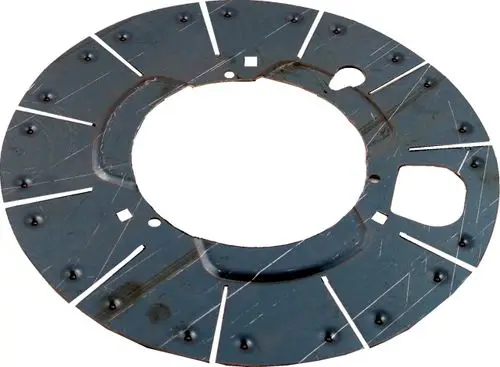 Schwarzes Metallblech mit runder Form und mehreren Öffnungen sowie Rillen. Teilweise verschlissene Oberfläche. Hersteller ist Wolf.